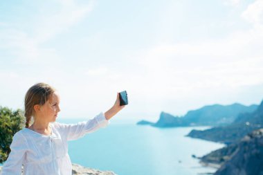 Küçük kız resim Smartphone'da alır.