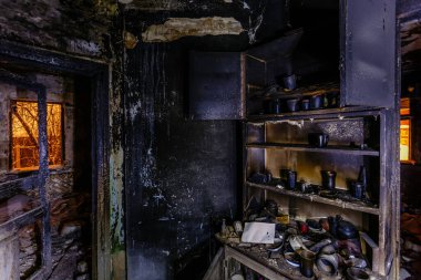 Burnt house interior. Burned furniture, charred walls and ceilin