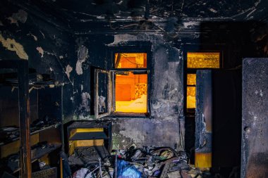 Burnt house interior. Burned furniture, charred walls and ceiling in black soot