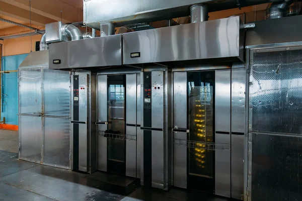 Modern bakery in confectionery factory. Industrial ovens for baking biscuits, cakes and cookies