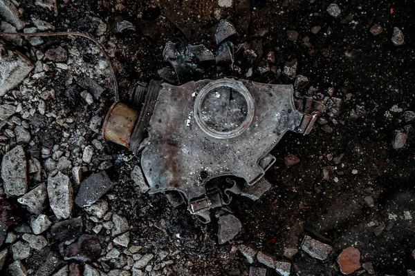 Old rotten Soviet gas mask on dirty floor of abandoned factory.