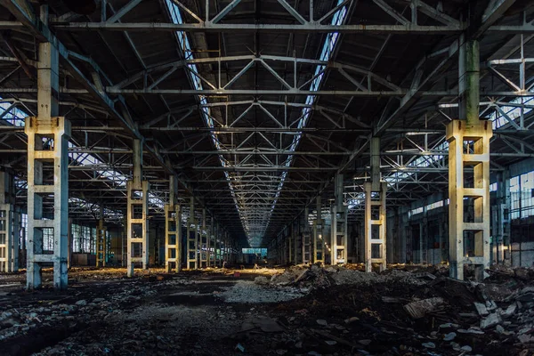Abandoned large industrial hall with garbage waiting for demolition. Former Voronezh excavator manufacturing factory.