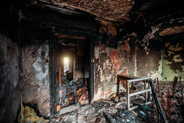 Burnt old rural house interior. Consequences of fire.