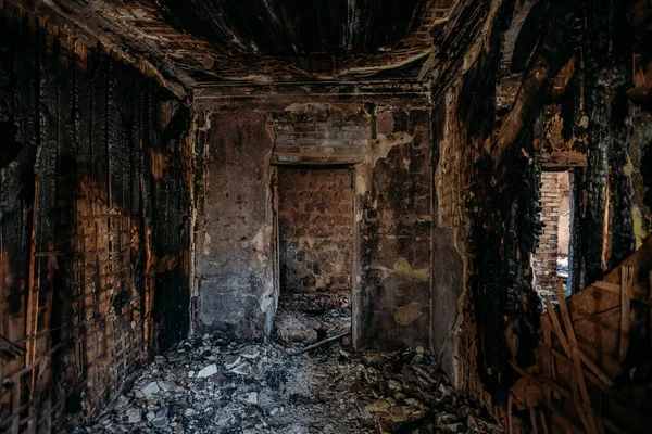 Burnt old rural house interior. Consequences of fire.