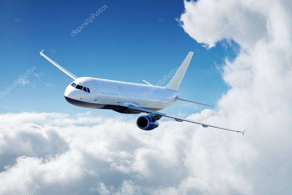 Airplane in the sky flying above the clouds at sunny day