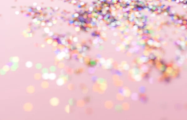 Defocused confetti on pink background — ストック写真