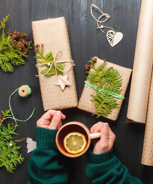 Weihnachtsgeschenke in Bastelpapier einwickeln — Stockfoto