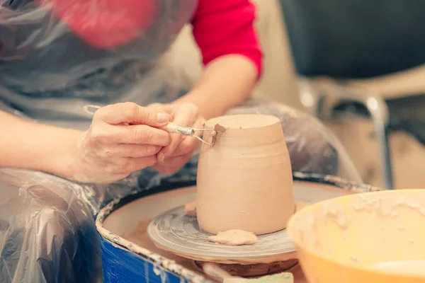 The process of creating a ceramic cup on a potter\'s wheel