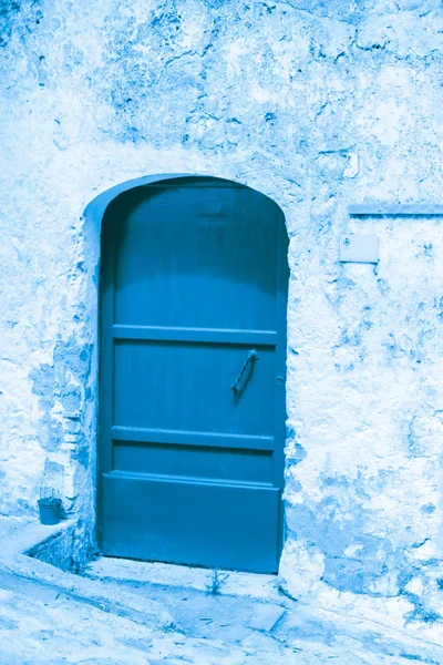 Niebieskie drzwi w białym stiuku ściany — Zdjęcie stockowe