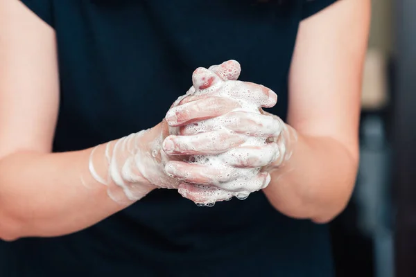 Front view on womans hands with soap foam, personal hygiene concept