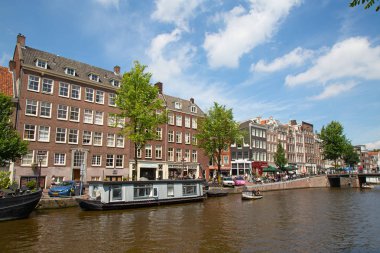 Amsterdam - 10 Temmuz 2016: geleneksel Hollanda evleri tarafından çevrelenmiş Amsterdam kanalları şehir.