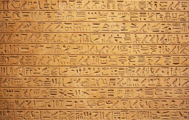 Closeup of Egyptian hieroglyphs on wall clipart