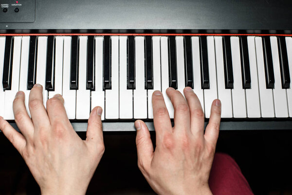 the pianist plays the piano. The pianist's hands closely. the view from the top .