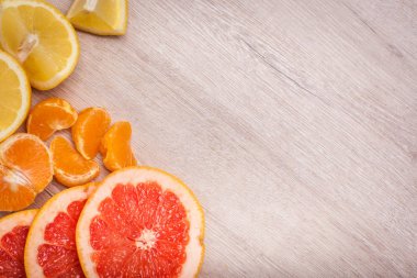limon, portakal, kivi, greyfurt, mandalina ahşap bir yüzey üzerinde. dilimlenmiş meyve tanzimi. Metin kopyalama yeri olan Üstten Görünüm