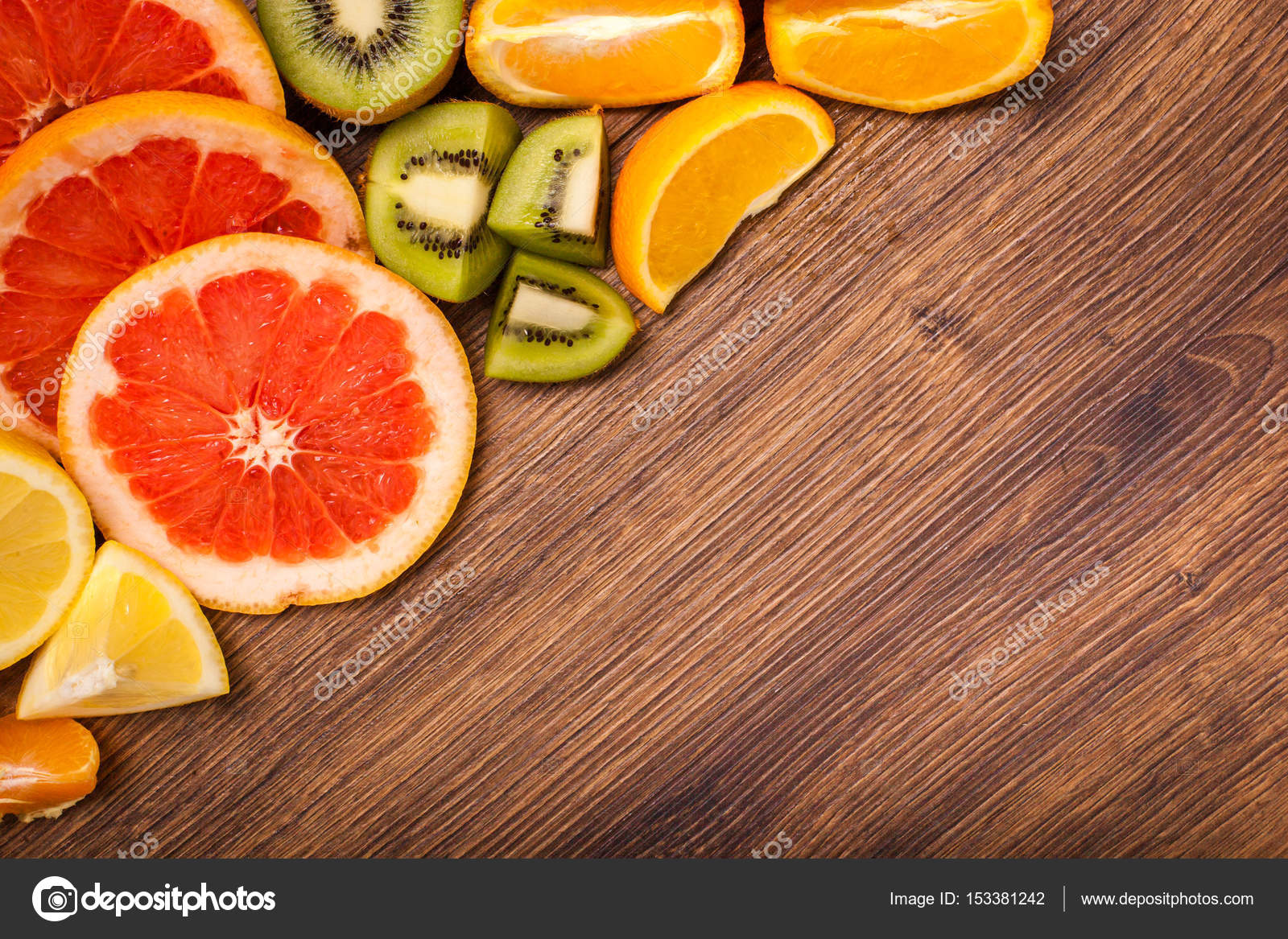 Lemon, orange, kiwi, grapefruit, mandarin on a wooden surface