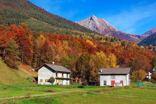 Venkovské domy a podzimní hory ve Švýcarsku. — Stock fotografie