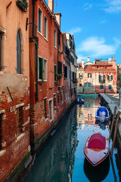 Narow canal with boats in Venice, Italy. Royalty Free Stock Images