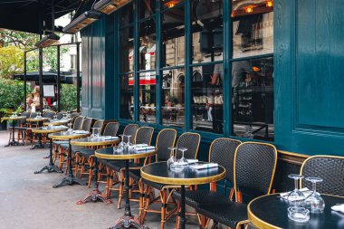 Tables and chairs in outdoor cafe in Paris, France. clipart
