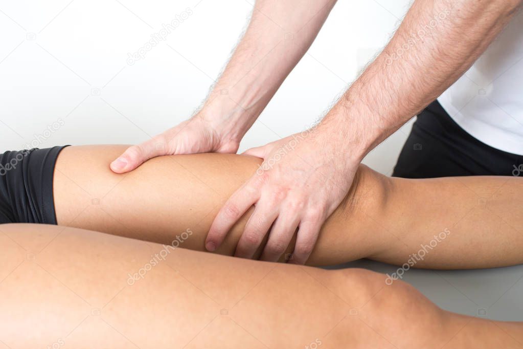 Massage therapist giving a leg massage