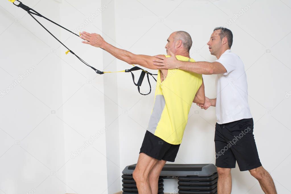Man helps with suspension training