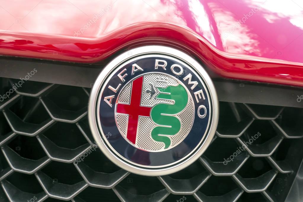 BAD NAUHEIM, GERMANY AUGUST 2017: ALFA ROMEO logo on a red car.