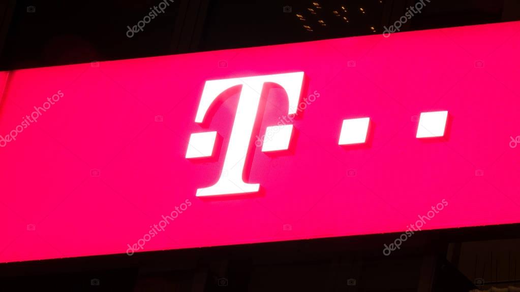 GIESSEN  GERMANY DECEMBER 2017: Illuminated pink Logotype of  Telekom.  Telekom is a telephone provider chain based in Bonn, Nordrhein-Westfalen.
