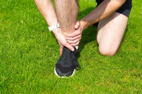Man hold his ankle — Stock Photo, Image