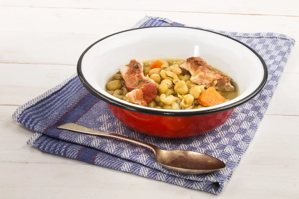 Peas soup with carrots and pork meat in an enamel bowl — Stockfoto