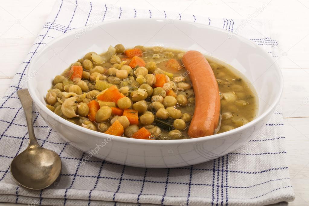 peas soup with carrots and sausage in a deep plate
