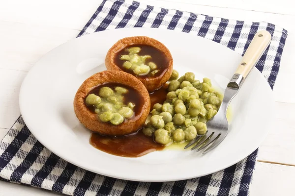 Yorkshire pudding with gravy and mushy pea — Stock Photo, Image