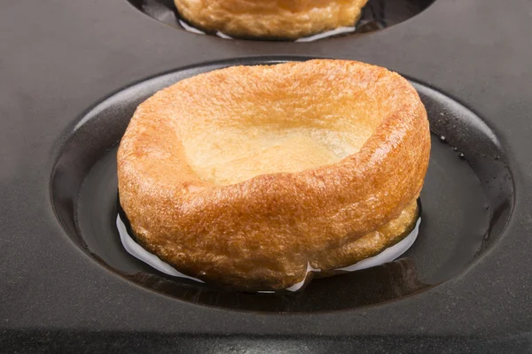 Freshly baked yorkshire pudding in a baking tray — Stock Photo, Image