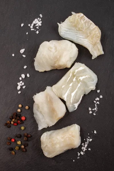 Cod chunks with coarse salt and peppercorn — Stock Photo, Image