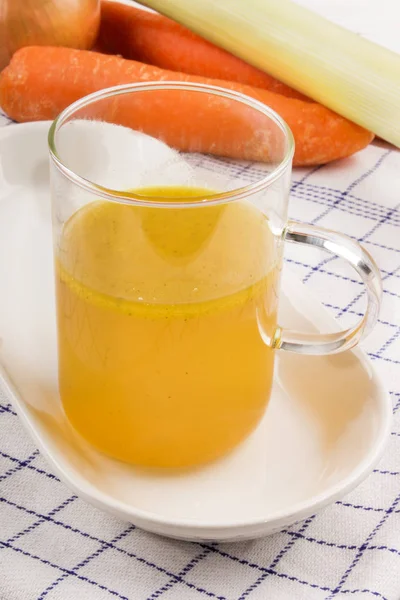 Home made chicken broth in a glass good against flue during the — Stock Photo, Image