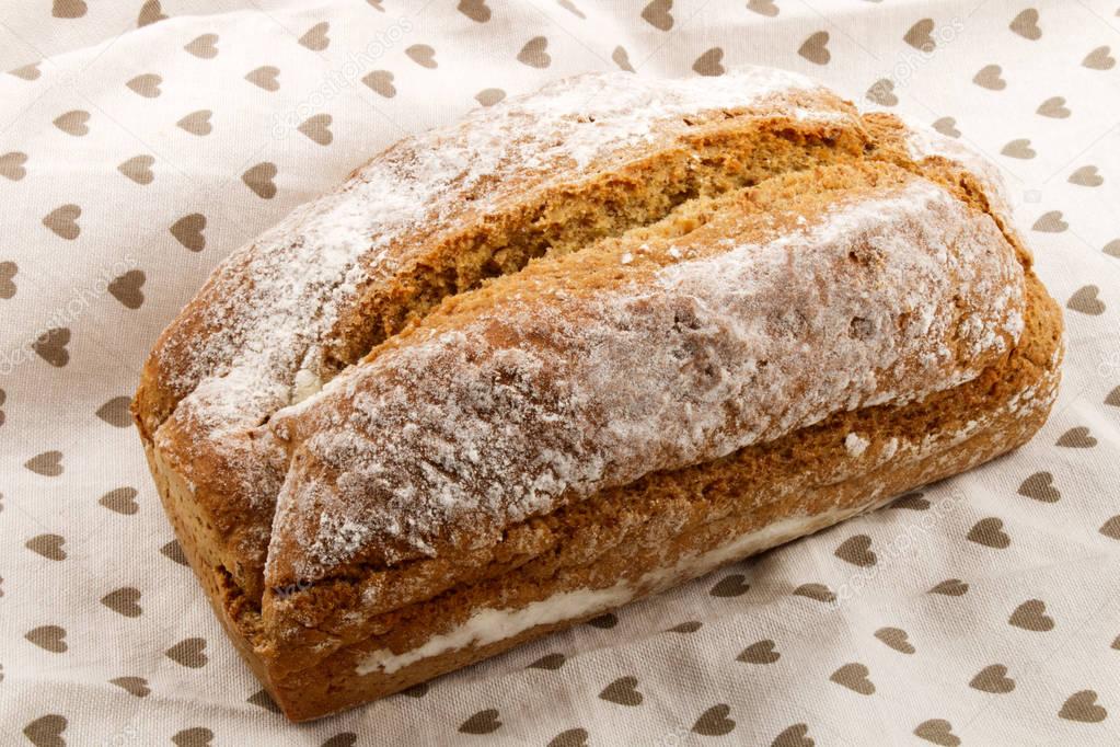 freshly baked, warm irish soda bread in a kitchen towel
