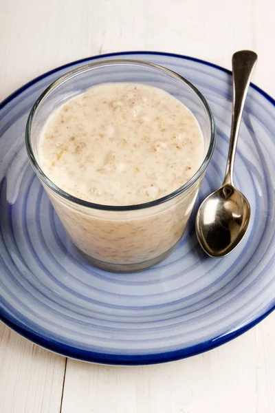 Creamy porridge in a glass on plate — Stock Photo, Image