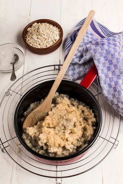 Fresh warm porridge in an enamel pot — Stock Photo, Image