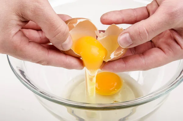 One fresh egg is broken and placed in a glass bowl — Stock Photo, Image