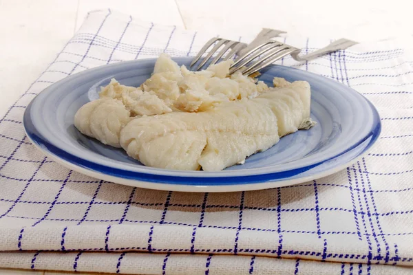 Boiled hake filet on a plate with fork — Stock Photo, Image