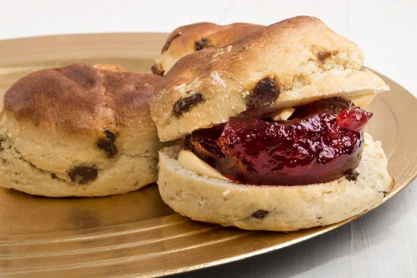 Fruit scone with butter and strawberry jam on a plate — Stock Photo, Image