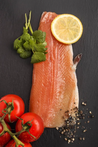 Raw trout fillet on slate — Stock Photo, Image