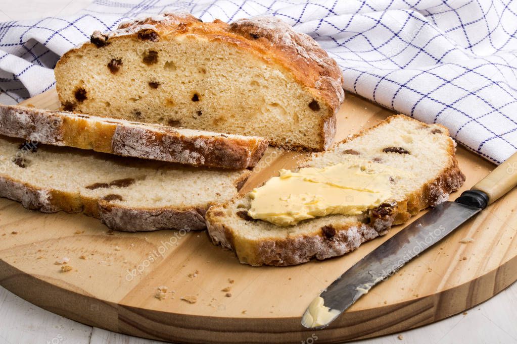 slice irish raisin soda bread with butter and knife