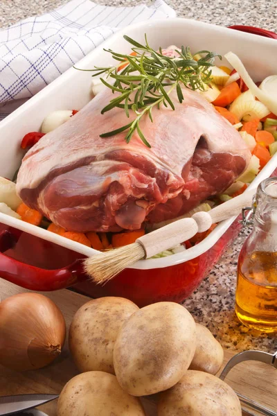 Raw leg of lamb with vegetable in a pan — Stock Photo, Image