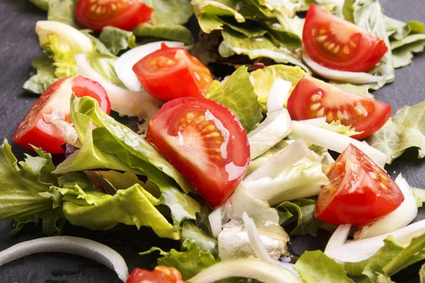 Fresh summer salat with oil on slate — Stock Photo, Image