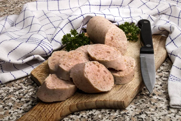 Raw irish white pudding cut into slices on a wooden board — Stock Photo, Image