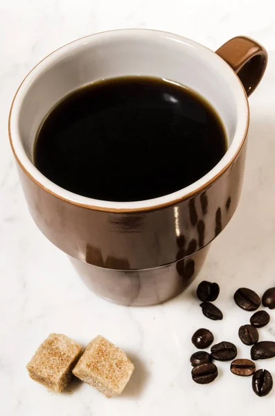 Cup with black coffee and brown sugar — Stock Photo, Image