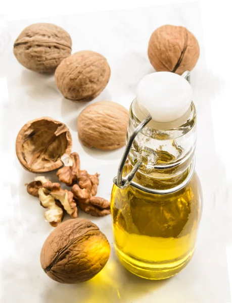 Walnut oil in a bottle on marble — Stock Photo, Image