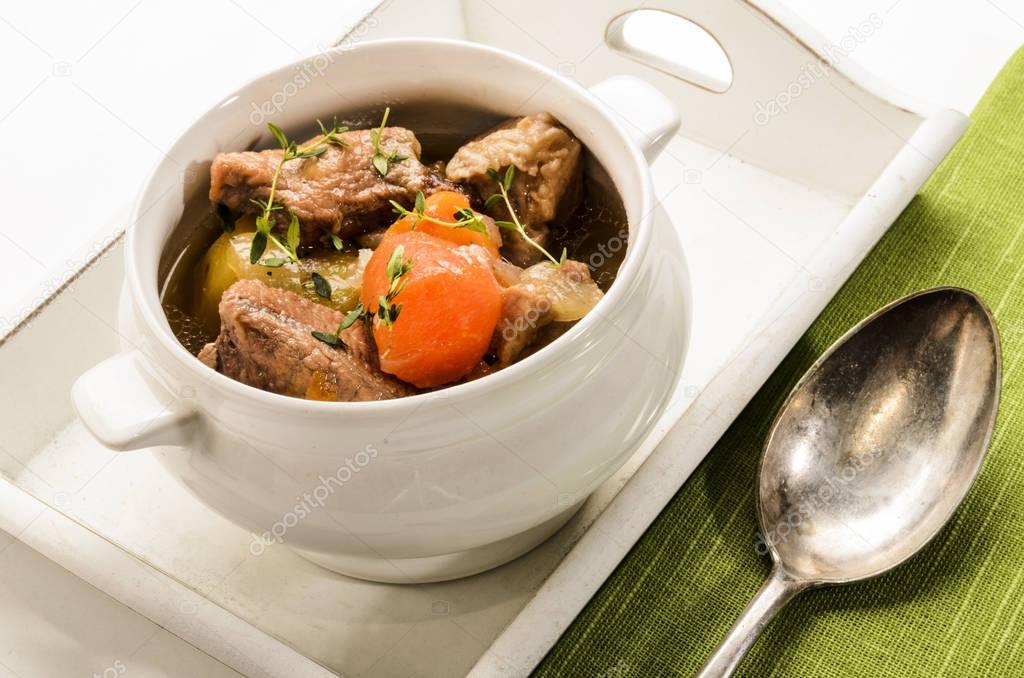 traditonal irish stew in a bowl, served on a tray