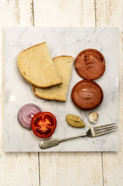 Grilled scalded sausage on a marble plate — Stock Photo, Image