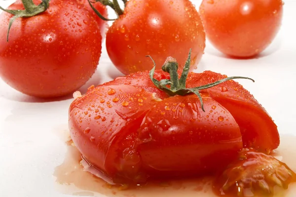 Squeezed tomato on white background — Stock Photo, Image