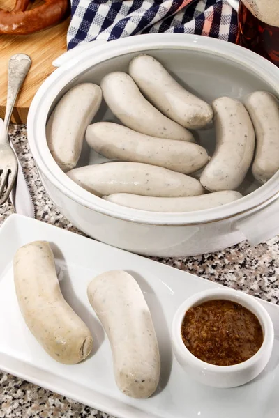 Bavarian white sausages in warm water in a terrine — Stock Photo, Image